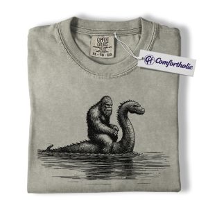 Bigfoot and Loch Ness Monster Shirt, Funny Cryptid T-Shirt, Sasquatch Riding Nessie Graphic Tee, Mythical Creature Gift, Funny Monster Comfort Colors Shirt
